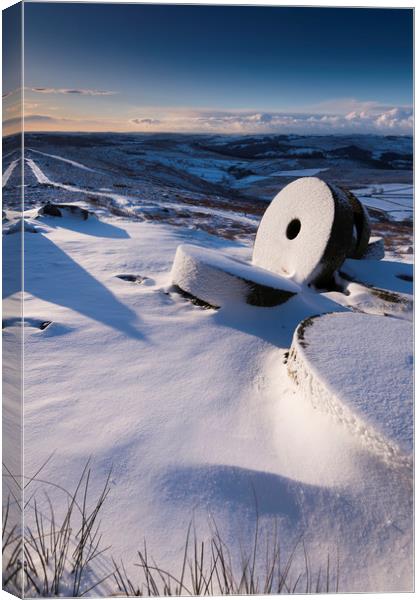 Millstones in the Snow, Derbyshire.  Canvas Print by John Finney