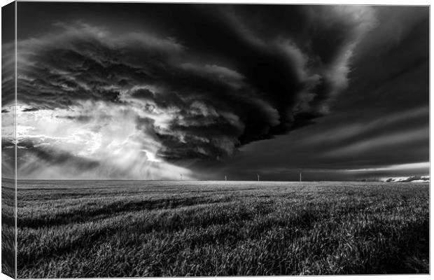 Sunlight through a storm. black and white Canvas Print by John Finney