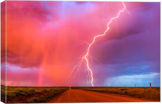 Monsoon sunset lightning with a rainbow Canvas Print by John Finney