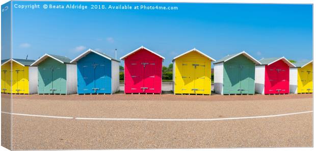 Colorful wooden beach huts in Eastbourne Canvas Print by Beata Aldridge