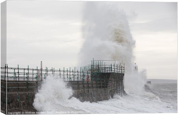 Waves crash over Porthcawl lighthouse Canvas Print by Andrew Bartlett