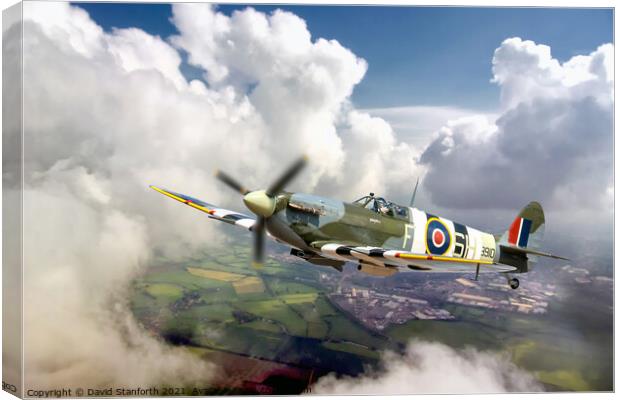 Spitfire breaks through the clouds Canvas Print by David Stanforth
