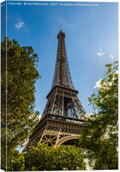 Eiffel Tower Through Trees Canvas Print by Paul Warburton