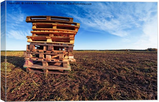 Pile Of Pallets On The Fields Canvas Print by Jukka Heinovirta