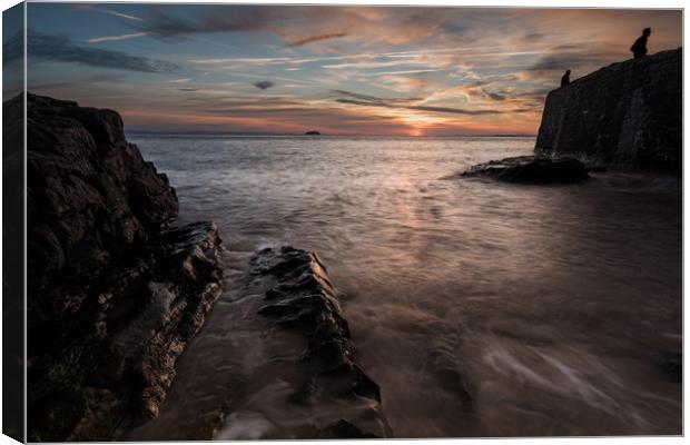 Silhouettes on the Sea Wall Canvas Print by Chris Sweet