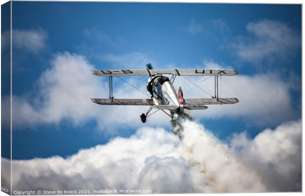 Old Biplane pulls up over the clouds Canvas Print by Steve de Roeck