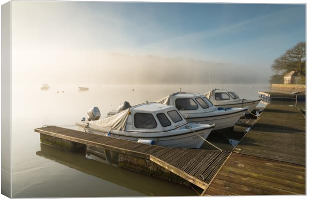 Moorings In Mist Canvas Print by Michael Brookes