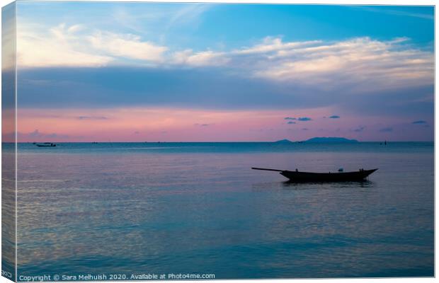 Boat at sunset Canvas Print by Sara Melhuish