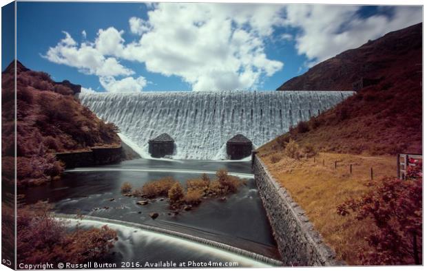 Caban Coch dam in full flow Canvas Print by Russell Burton