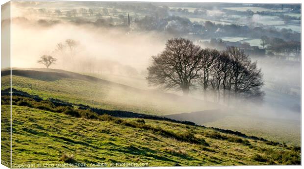 Bamford village shrouded in a mist inversion Canvas Print by Chris Drabble