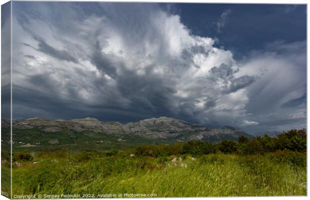 Mountain landscape with dramatic sky. A storm is coming from the mountains. Canvas Print by Sergey Fedoskin