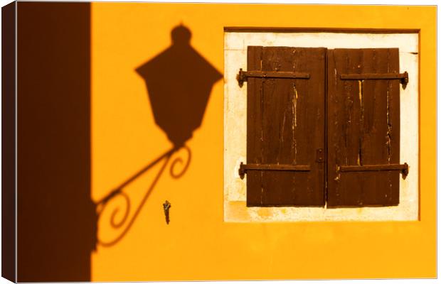 Street lamp shadow on a yellow wall. Canvas Print by Tartalja 