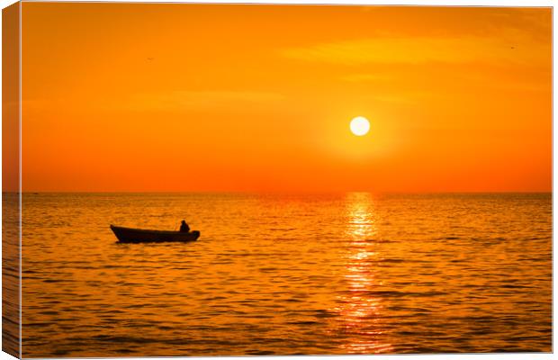 Sea sunset with a fishermans boat silhouette. Canvas Print by Tartalja 
