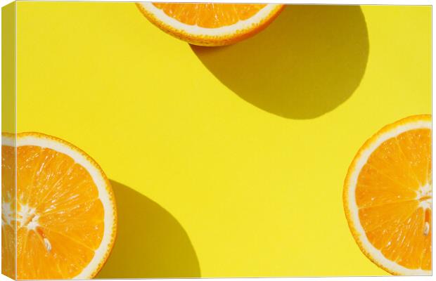 Oranges on yellow background Canvas Print by Tartalja 