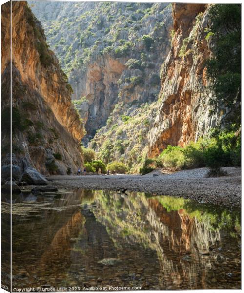 Tranquil Waters Beneath Mallorcan Peaks Canvas Print by Bruce Little