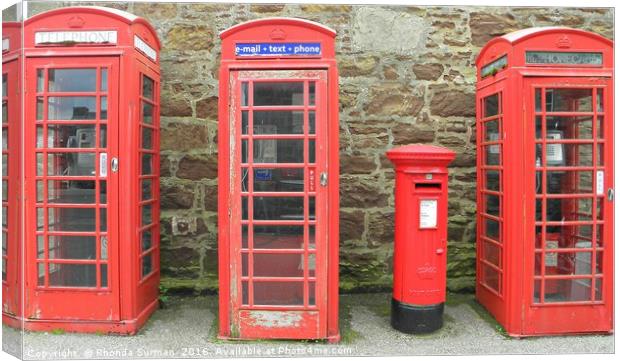 Iconic red telephone boxes with an iconic red post Canvas Print by Rhonda Surman