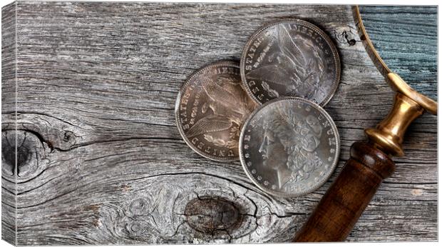 Collection of US Morgan silver dollars with magnifying glass  Canvas Print by Thomas Baker