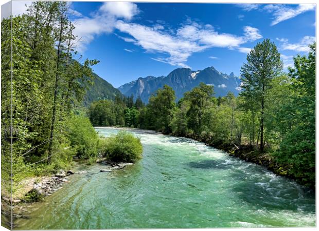 Gem green color Skykomish river with snowcapped cascade mountain Canvas Print by Thomas Baker