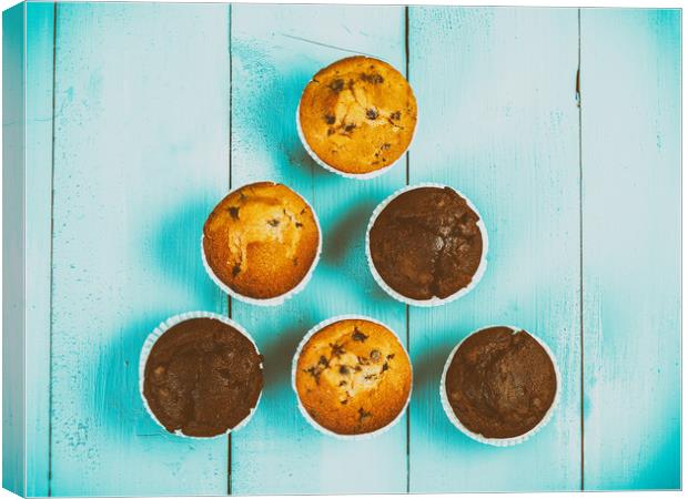 Homemade Chocolate Chip Muffins On Blue Table Canvas Print by Radu Bercan