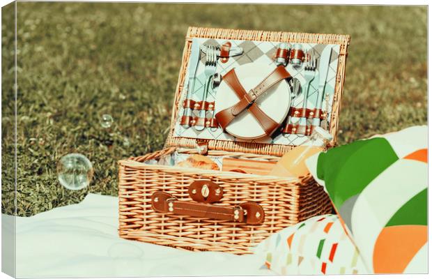 Picnic Basket Food On White Blanket With Pillows A Canvas Print by Radu Bercan