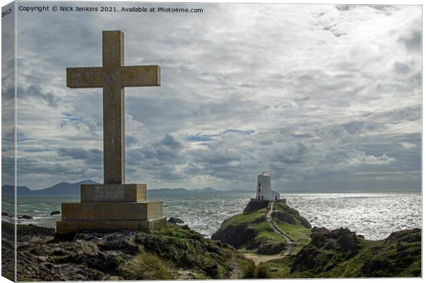 Cross overlooking the Lighthouse Llanddwyn Island Canvas Print by Nick Jenkins