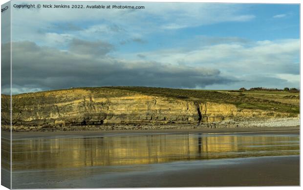 Dunraven Bay cliffs reflected in wet sand Canvas Print by Nick Jenkins