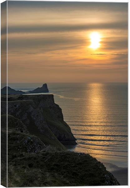 Sunset over the Worm's Head on the Gower Peninsula Canvas Print by Nick Jenkins
