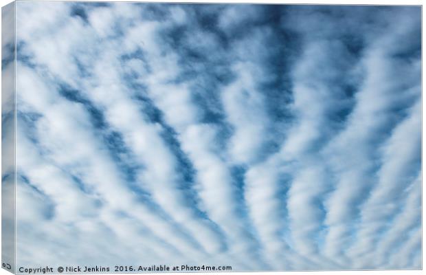 High White Furrow Clouds in a Blue Sky Canvas Print by Nick Jenkins
