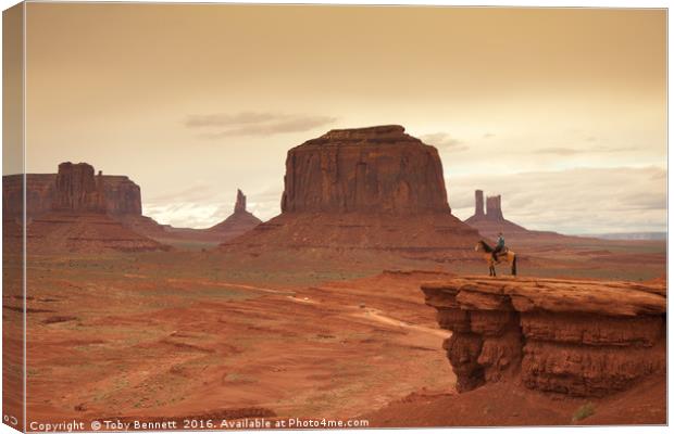 Lone Horseman Overlooks Monument Valley Canvas Print by Toby Bennett