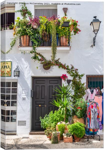 Floral display in Frigiliana in Andalusia, Spain Canvas Print by Angus McComiskey