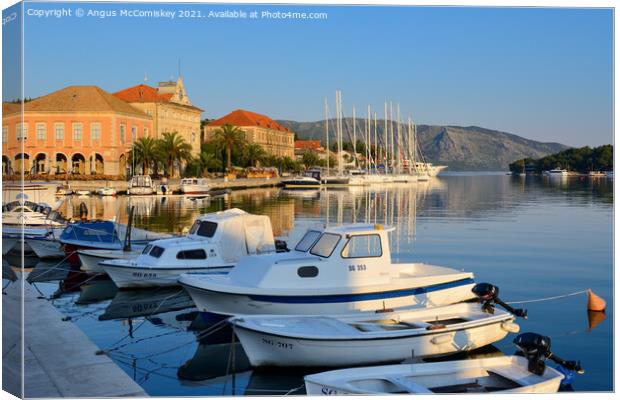 Boats moored in Stari Grad harbour, Croatia Canvas Print by Angus McComiskey
