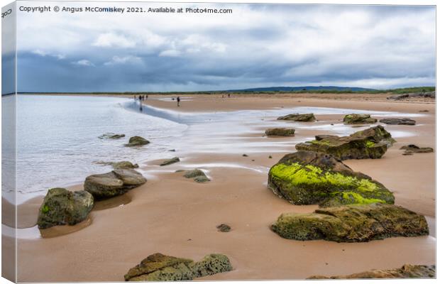 Dornoch beach looking south as the tide retreats Canvas Print by Angus McComiskey