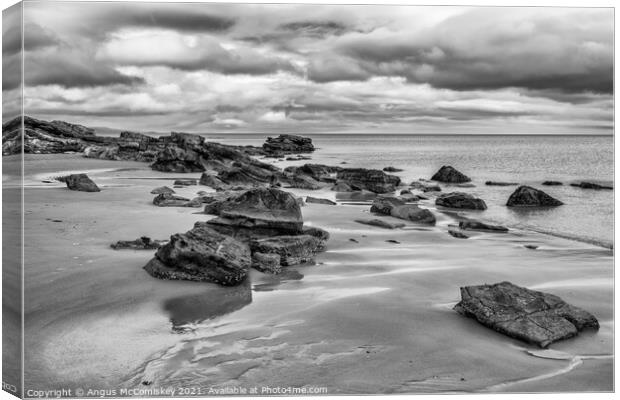 Rocks on Dornoch beach mono Canvas Print by Angus McComiskey