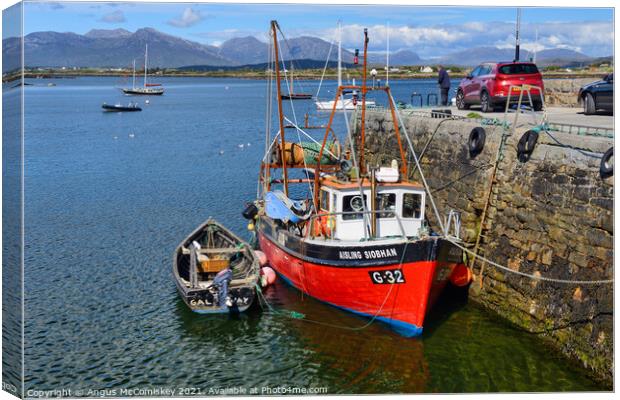 Fishing boat in Roundstone harbour, County Galway  Canvas Print by Angus McComiskey