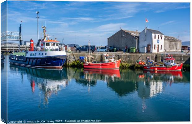 Boats on quayside at Stromness harbour in Orkney Canvas Print by Angus McComiskey