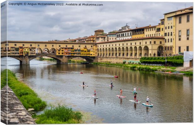 Paddle boarders on the Arno in Florence, Tuscany Canvas Print by Angus McComiskey