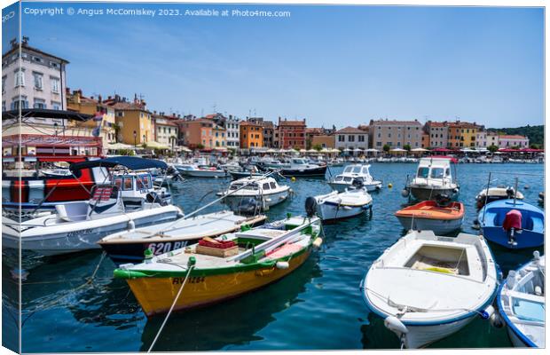 Boats moored in the Port of Rovinj in Croatia Canvas Print by Angus McComiskey