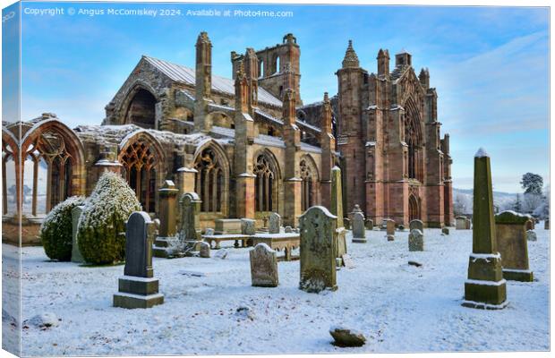 Ruins of Melrose Abbey in snow, Scottish Borders Canvas Print by Angus McComiskey