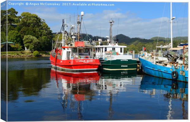 Fishing boat reflections Strahan harbour Tasmania Canvas Print by Angus McComiskey