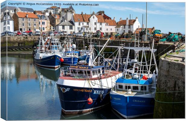 Fishing boats moored in Pittenweem Harbour Canvas Print by Angus McComiskey