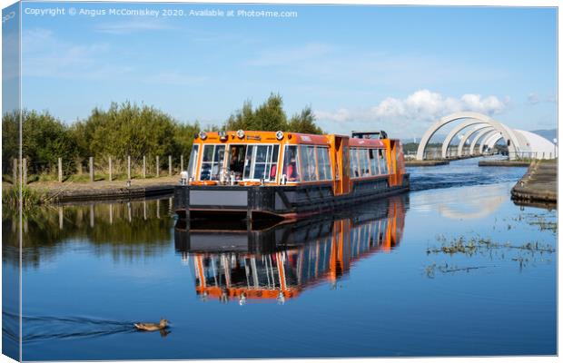 Canal boat leaving Falkirk Wheel behind Canvas Print by Angus McComiskey