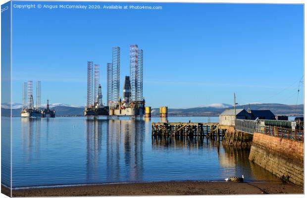 Decommissioned oil rigs off Cromarty harbour Canvas Print by Angus McComiskey