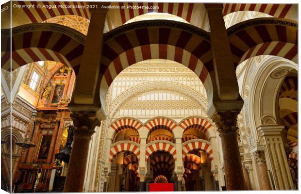 Pillars and arches in Cordoba Cathedral Canvas Print by Angus McComiskey