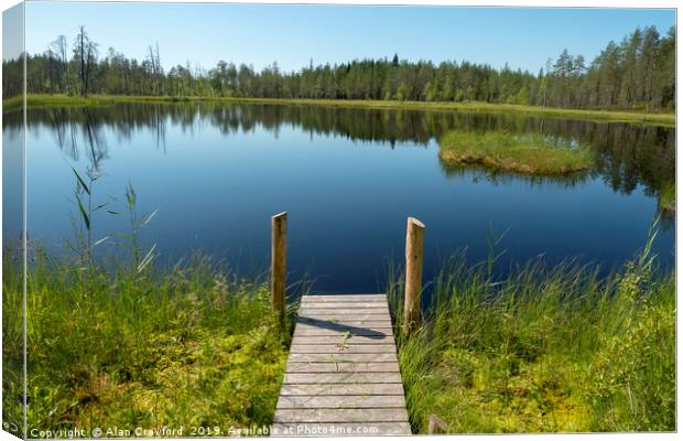 Jetty by a lake in Finland Canvas Print by Alan Crawford