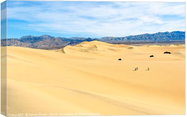 Three people walking across the sand dunes in Deat Canvas Print by Jamie Pham