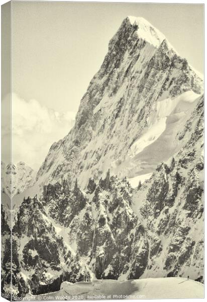 The tiny figure of a climber in front  of the Grandes Jorasses Canvas Print by Colin Woods
