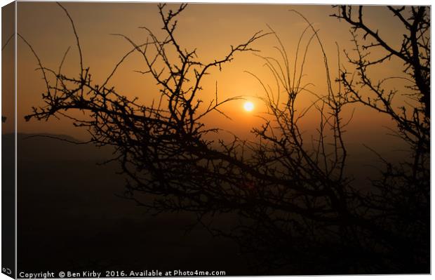 Sunset through the trees Canvas Print by Ben Kirby