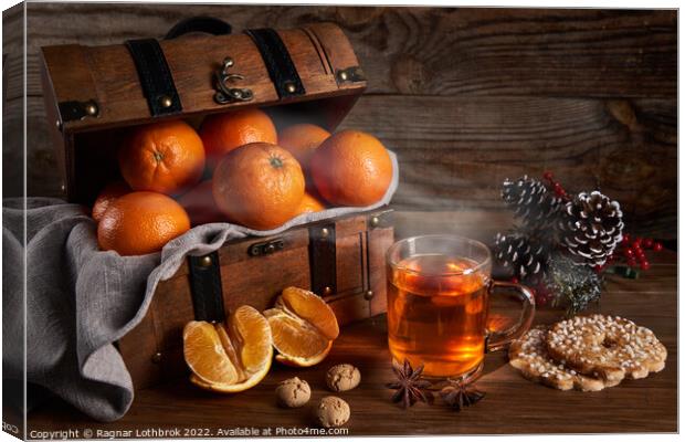 Hot tea and oranges in a wooden chest Canvas Print by Ragnar Lothbrok