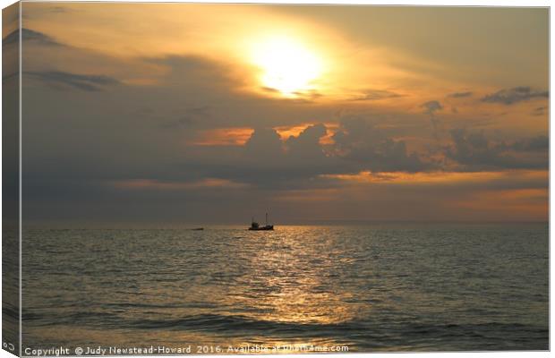 Boat on the sea at Holme, Norfolk Canvas Print by Judy Newstead-Howard