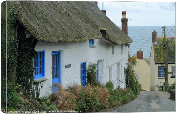 Thatched cottages by the sea Canvas Print by JUDI LION